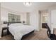 A bedroom including an ensuite bathroom, two bedside tables, and neutral wall paint at 18112 E 104Th Way, Commerce City, CO 80022