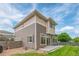 Exterior view of the multi-level home highlighting the architectural design and outdoor spaces with sliding glass doors at 18112 E 104Th Way, Commerce City, CO 80022