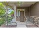 Inviting front porch with stone accents, modern lighting, and a stylish entry door at 18112 E 104Th Way, Commerce City, CO 80022