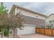 Spacious two-car garage featuring a brick-paved driveway and a contemporary home exterior at 18112 E 104Th Way, Commerce City, CO 80022