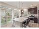 Modern kitchen with stainless steel appliances, granite countertops, and an island with seating at 18112 E 104Th Way, Commerce City, CO 80022