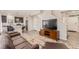 Open-concept living room featuring sleek flooring, modern decor, and a staircase at 18112 E 104Th Way, Commerce City, CO 80022