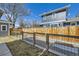 Fenced backyard featuring garden beds, and gravel, providing a private outdoor space at 4441 N Meade St, Denver, CO 80211