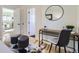 Bedroom view highlighting a desk setup, cowhide rug, and doorways leading to other rooms at 4441 N Meade St, Denver, CO 80211
