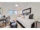 Bright bedroom with a wooden desk, chair, soft lighting, and hardwood floors covered with a cowhide rug at 4441 N Meade St, Denver, CO 80211