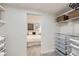 Well-organized walk-in closet with custom shelving, baskets, and a glimpse of a bedroom at 4441 N Meade St, Denver, CO 80211