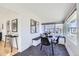 Dining room features a built-in bench, black chairs, and modern artwork, bathed in natural light at 4441 N Meade St, Denver, CO 80211