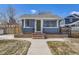 Charming single-story home featuring a well-kept lawn, classic brick accents, and a bright green front door at 4441 N Meade St, Denver, CO 80211