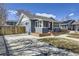 Charming blue home with brick foundation, well-manicured front yard, and inviting curb appeal at 4441 N Meade St, Denver, CO 80211
