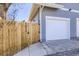 Exterior shot of a garage and fenced in side yard, painted a modern gray at 4441 N Meade St, Denver, CO 80211