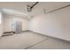 Spacious garage with epoxy flooring, ample lighting, and storage cabinets at 4441 N Meade St, Denver, CO 80211