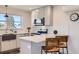 Eat-in kitchen featuring granite countertops, modern white cabinets, stainless steel appliances and barstool seating at 4441 N Meade St, Denver, CO 80211