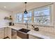 Bright kitchen featuring an undermount sink, white countertops, white tiled backsplash, and modern faucet at 4441 N Meade St, Denver, CO 80211