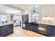 Modern kitchen featuring stainless steel appliances, a large sink, and dark blue cabinets at 4441 N Meade St, Denver, CO 80211