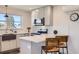 Well-appointed kitchen with stainless steel appliances, breakfast bar, and modern finishes at 4441 N Meade St, Denver, CO 80211
