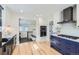 Updated kitchen offers modern stainless appliances, two-tone cabinets, and granite countertops at 4441 N Meade St, Denver, CO 80211