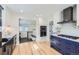 Stylish kitchen with stainless steel appliances, granite countertops and navy cabinets at 4441 N Meade St, Denver, CO 80211