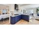 Stylish kitchen with white subway tile, dark blue cabinets, and stainless steel appliances at 4441 N Meade St, Denver, CO 80211