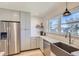 Spacious kitchen featuring stainless steel refrigerator, light gray cabinets, and an undermount sink at 4441 N Meade St, Denver, CO 80211