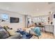 Open-concept living area seamlessly connects to a modern kitchen, complete with stylish furnishings and natural light at 4441 N Meade St, Denver, CO 80211