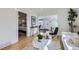 Open concept living room view showcasing a bedroom entrance, hardwood floors, and stylish decor at 4441 N Meade St, Denver, CO 80211