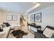 Cozy living room with white couch, decor, carpet, and steps to the upper level at 4441 N Meade St, Denver, CO 80211