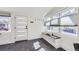 Modern mudroom with sleek gray chevron floors, built-in storage bench, and a contemporary white door at 4441 N Meade St, Denver, CO 80211