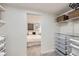 A look inside a closet with built-in shelves and drawer storage with a bedroom shown beyond at 4441 N Meade St, Denver, CO 80211