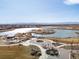 Scenic aerial view of the community's large lake with walking paths and mountain views at 5072 Lake Port Ave, Firestone, CO 80504