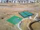 Aerial view showcases the community tennis and basketball courts, adjacent to walking path at 5072 Lake Port Ave, Firestone, CO 80504