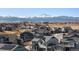 The aerial view captures the community homes with snow capped mountains in the background at 5072 Lake Port Ave, Firestone, CO 80504