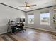 Bedroom featuring wood floors, a ceiling fan, and dual windows offering ample natural light at 5072 Lake Port Ave, Firestone, CO 80504