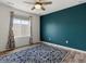 A well-lit bedroom featuring wood floors, a blue accent wall, and a ceiling fan at 5072 Lake Port Ave, Firestone, CO 80504