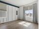 An empty bedroom features wood floors and a large window at 5072 Lake Port Ave, Firestone, CO 80504