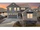 Charming two-story home with stone accents, gray siding and an attached two car garage at 5072 Lake Port Ave, Firestone, CO 80504