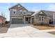 Beautiful two-story home with gray siding, stone accents, and a spacious three car garage at 5072 Lake Port Ave, Firestone, CO 80504