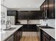 Sleek kitchen with stainless steel appliances, dark cabinetry, and white quartz countertops at 5072 Lake Port Ave, Firestone, CO 80504