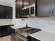 Close up shot of the kitchen with a gas range and stainless steel microwave and quartz counters at 5072 Lake Port Ave, Firestone, CO 80504