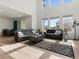 Bright living room with high ceilings, lots of natural light, and wood laminate flooring at 5072 Lake Port Ave, Firestone, CO 80504