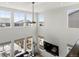 Two-story living room with a ceiling fan, large windows, and wall-mounted TV at 5072 Lake Port Ave, Firestone, CO 80504