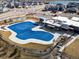 Aerial view showcases community pool and recreational areas with nearby houses at 5072 Lake Port Ave, Firestone, CO 80504