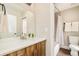 Bathroom featuring a modern vanity with a sink, a large mirror, and a shower/tub combo at 3864 Osceola St, Denver, CO 80212