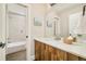 Bathroom featuring modern vanity with sink, large mirror, and tiled shower/tub combo at 3864 Osceola St, Denver, CO 80212