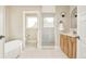 Bright bathroom featuring a glass shower, double vanity with wood cabinets, white counters, and neutral walls and tile at 3864 Osceola St, Denver, CO 80212