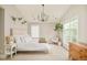 Bright bedroom featuring large windows, modern chandelier, neutral decor, and light colored walls and carpeting at 3864 Osceola St, Denver, CO 80212