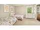 Bright bedroom featuring two twin beds, dresser, and floral themed bedding at 3864 Osceola St, Denver, CO 80212