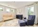 Charming Bedroom with crib, changing table, chair, and a large window at 3864 Osceola St, Denver, CO 80212