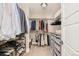 Organized walk-in closet with hanging clothes, shoe racks, and storage drawers at 3864 Osceola St, Denver, CO 80212