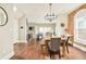 Open-concept dining room with hardwood floors and modern lighting fixture at 3864 Osceola St, Denver, CO 80212
