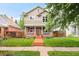Charming two-story home with a welcoming front porch, landscaped yard, and inviting curb appeal at 3864 Osceola St, Denver, CO 80212